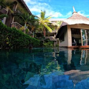 a swimming pool in front of a resort at Residence Alizees Spa in Mauritius
