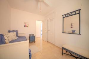 a bedroom with a bed and a mirror on the wall at El Faro 18 in La Herradura +19 photos