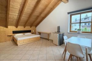 a bedroom with a bed and a desk and a table at NEU! Ferienwohnung Durach in Durach