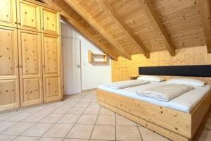 a bedroom with a wooden bed in a room at NEU! Ferienwohnung Durach in Durach