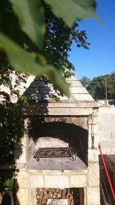 a stone brick oven with a roof at Apartman Vito in Medulin