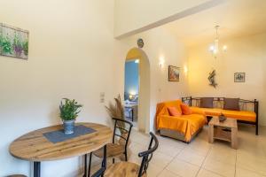 a living room with a table and a couch at Nikos Seaside Apartment in Agia Pelagia Chlomou