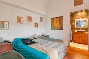 a bedroom with a large bed and a dresser at La Tanière in La Baule