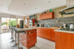 a kitchen with wooden cabinets and a counter top at La Tanière in La Baule