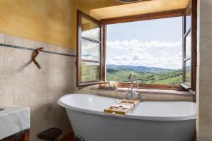 a bath tub in a bathroom with a window at Casa al Poggio and Chianti view in San Donato in Poggio +22 photos