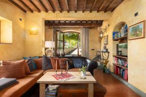 a living room with a leather couch and a table at Casa al Poggio and Chianti view in San Donato in Poggio