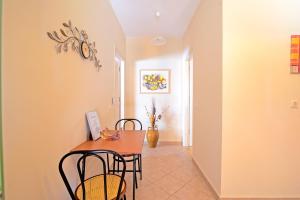 a dining room with a table and chairs at Villa Pepy Studio 3 in Mesongi +14 photos