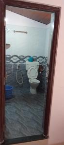 a bathroom with a toilet and a bunch of wires at Lewis Paradise Homestay in Kalyānpur +11 photos