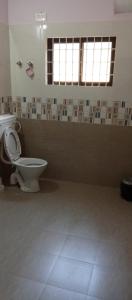 a bathroom with a toilet in a room at Lewis Paradise Homestay in Kalyānpur