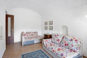 a living room with a couch and a chair at Villa Rita al Vesuvio in Terzigno