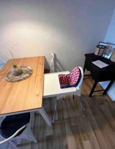 a wooden table with a chair next to a desk at Schöne Dachgeschosswohnung in Magdeburg +2 photos
