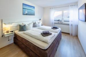 a bedroom with a large bed with a window at Fewo Bodenseeoase in Wangen