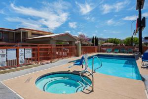 a swimming pool with a slide in the middle at Econo Lodge Hurricane Zion Park Area in Hurricane