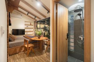 a small room with a table and a shower at Lakeside Horizon Boutique Suites-1 min to Hoan Kiem Lake-Free Airport in Hanoi