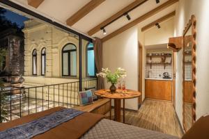 a room with a bed and a table on a balcony at Lakeside Horizon Boutique Suites-1 min to Hoan Kiem Lake-Free Airport in Hanoi