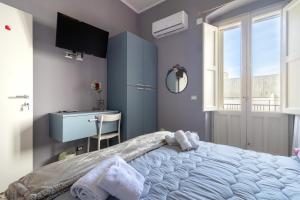 a bedroom with a large bed and a desk at Dormiamoci Sù in Mottola