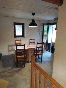 a dining room with a table and chairs at Maison Dans les Pyrénées audoises in Roquefeuil