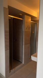 a bathroom with a shower with a glass door at Výrovka in Pec pod Snezkou
