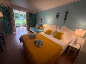 a bedroom with a large bed with towels on it at TI COCOTIER Studio PREMIUM Village Vacances in Sainte-Luce +26 photos