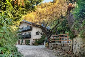 a large white house in the middle of a forest at Alter Fausthof in Fie allo Sciliar