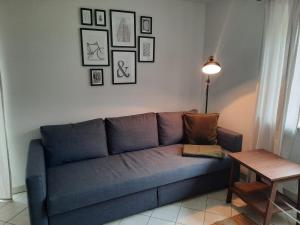 a blue couch in a living room with a table at Ferienwohnung No15 in Pfullendorf