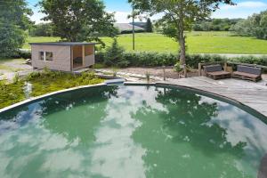 a view of a swimming pool with a tiny house at Ferienwohnung Bodensee in Schnerkingen