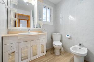 a white bathroom with a sink and a toilet at Ca La Lola in Llorenç del Penedes +18 photos