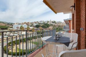 a balcony with a table and chairs and a view at Blue Coast Apartment in Canet de Mar