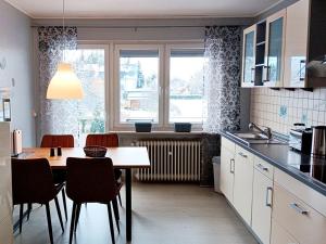 a kitchen with a table and chairs and a window at Abendsonne Obergeschoss mit Balkon in Koblenz