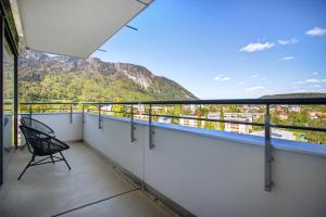 a balcony with a chair and a view of a mountain at The View in Bad Reichenhall