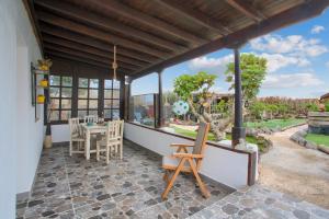 a screened in porch with a table and chairs at El Cuarto De Moza in Tinajo
