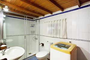 a bathroom with a toilet and a sink and a shower at La Chirlaca in Tijarafe +15 photos