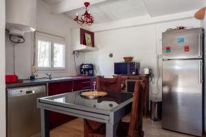 a kitchen with a stainless steel refrigerator and a sink at Le Cabanon de Valérie in Sanary-sur-Mer +14 photos