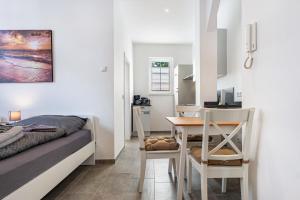 a small apartment with a bed and a table and a kitchen at Speicherapartment in Warendorf +12 photos