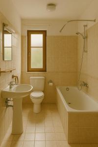 a bathroom with a toilet and a tub and a sink at Orange Rooms in Tirana