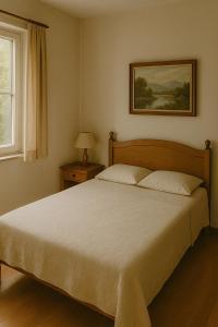 a bedroom with a large bed and a window at Orange Rooms in Tirana