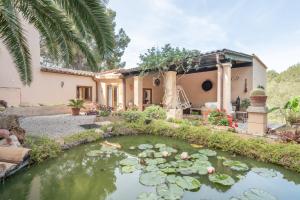 a house with a koi pond in front of it at Casa Vista Monte in Llucmajor