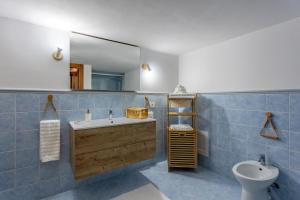 a bathroom with a sink and a toilet and a mirror at Casa Altoliva in Marsala