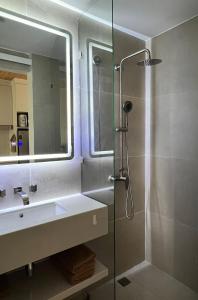 a bathroom with a shower and a sink and a mirror at Studio in a modern complex Wing Samui Condo in Amphoe Koh Samui