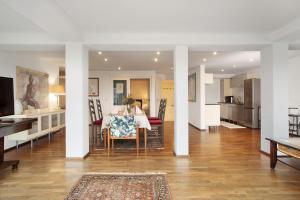 a living room with a table and a kitchen at Ferienwohnung Marianne in Langen bei Bregenz