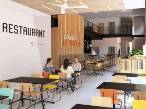 two women sitting at tables in a restaurant at HI Poitiers - La Caserne in Poitiers +4 photos