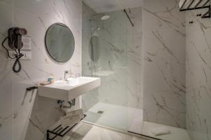 a white bathroom with a sink and a mirror at Luces de Catedral in Alicante +98 photos