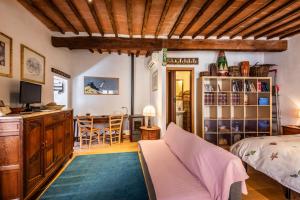 a bedroom with a bed and a dining room at Apartment In The Medieval Village in Radicondoli