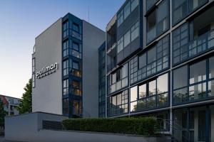 a building with a sign on the side of it at Pullman Munich in Munich