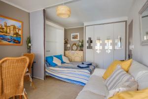 a living room with a couch and a table at Bellevue Cannes in Cannes +18 photos