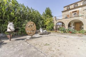 HostafrancoにあるCal Masoの2体の彫像と建物のある中庭