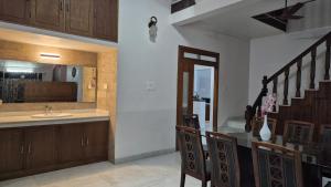 a kitchen with a sink and a counter with a sink at Thistle Cosy Villa in Kozhikode