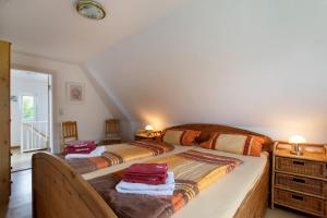 a bedroom with two beds and a dresser at Hus an Diek in Hillgroven