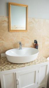 a white sink in a bathroom with a mirror at Comfy stay in East London
