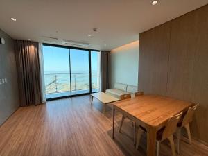 a dining room with a table and a view of the ocean at Seohaemaroo Youthhostel in Hwaseong